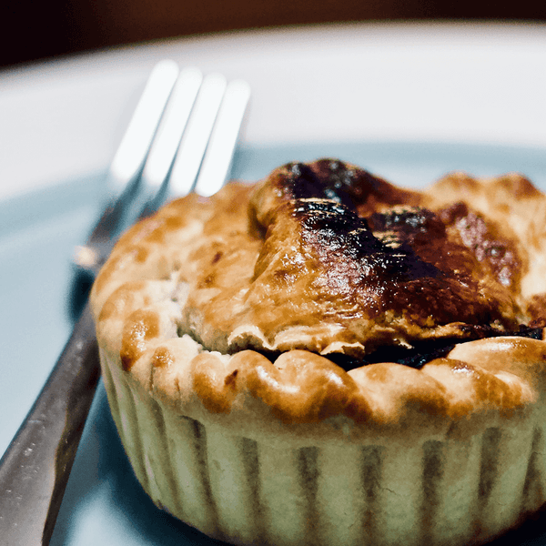 Roast Potatoes, Mushrooms In a Cream Sauce and Sliced Rare Sirloin Steak On White Plate